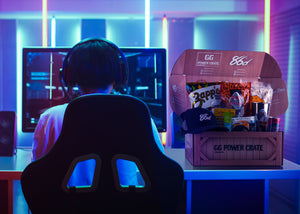 Computer video gamer gaming next to GG Power Crate gift box and gift basket for gamers